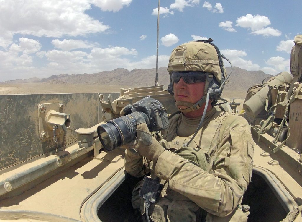 U.S. Army Staff Sgt. Brendan Mackie, photojournalist with the Hawaii Army National Guard's 117th Mobile Public Affairs Detachment, photographs from the back of a Stryker fighting vehicle during Operation Buffalo Thunder II in Shorabak district, Kandahar province, Afghanistan, June 27, 2012. Mackie is from Delaware City, Del. (U.S. Army photo by Staff Sgt. Brendan Mackie/Released)