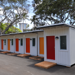 Photo of Pūlama Ola kauhale, the Governor’s medical respite community located in the parking lot of the Hawaiʻi State Department of Health. It provides a place for people experiencing homelessness to rest and recover after they have been discharged from hospitals.