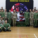 U.S. Soldiers and soldiers of the Singapore Armed Forces, take a photo during the opening ceremony for Exercise Tiger Balm 25 at Mandai Hill Camp, Singapore, May 5, 2025. Tiger Balm is a bilateral training exercise that enhances combined interoperability between the U.S. and Singapore armies. (U.S. Army National Guard photo by Sgt. Mariah-Alexsandra Manandic-Kapu)(This photo has been altered for security purposes by blurring out the photos.)