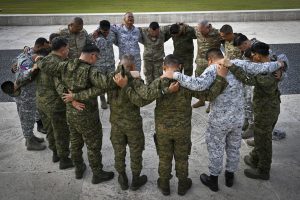 Chaplains from the Armed Forces of the Pacific, Hawaii and Guam Army National Guards embrace and pray during a visit to the Manila American Cemetery and Memorial, Feb. 20, 2026, Taguig, Metro Manila, Philippines. The cemetery and memorials contain the graves of military fallen and the names of the missing-in-action from WW2. The visit was part of a State Partnership Program Subject Matter Expert Exchange and allowed for reflection on their roles as military chaplains. The State Partnership Program links a State's National Guard with foreign partner nations to build long-term, mutually beneficial security relationships. (U.S. Air National Guard photo by Tech. Sgt. Orlando Corpuz)