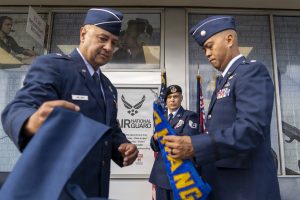 Air Force Brig. Gen. Phillip L. Mallory, Hawaii Air National Guard commander and Air Force Lt. Col. Michael Buendia, Headquarters Hawaii Air National Guard Recruiting Flight commander, unfurl the Headquarters Hawaii Air National Guard Recruiting and Retention Flight guidon during the unit's activation ceremony held at Pearl Highlands Center in Pearl City, Hawaii, Aug. 1, 2026. Before the flight’s activation, recruiting and retention efforts fell under the HIANG personnel directorate. The establishment of the HIANG’s first dedicated Recruiting and Retention Flight creates a team focused on recruiting new Airmen, retaining experienced personnel and strengthening accession support across the organization. (U.S. Air National Guard photo by Tech. Sgt. Orlando Corpuz)