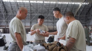 Airmen from the Hawaii Air National Guard familiarize themselves with the contents of a field medics kit during the hands on portion of self-aid and buddy care training during August's unit training assembly, Aug. 9, 2015, Joint Base Pearl Harbor-Hickam. (U.S. Air National Guard Photo by Tech. Sgt. Andrew Jackson)