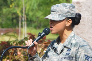 Senior Airman Jaime Aquino with the 154th Civil Engineering Squadron, Hawaii Air National Guard, sings the national anthem at a ground breaking ceremony for a solar array facility being built for the HIANG at Joint Base Pearl Harbor-Hickam, Oct. 27, 2015. The solar array facility will be one piece of the HIANG's renewable energy strategy to decrease it's electricity expense and increase it's energy security. (U.S.Air National Guard photo by Senior Airman Orlando Corpuz/Released)