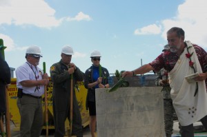 Officials for the Hawaii Air National Guard look on as Hawaiian "Kahu" or priest Roy Brooks performs a traditional Hawaiian blessing on the cornerstone pillar of a future solar array facility being built at Joint Base Pearl Harbor-Hickam, Oct. 27, 2015. The solar array facility will be one piece of the HIANG's renewable energy strategy to decrease it's electricity expense and increase it's energy security. (U.S.Air National Guard photo by Senior Airman Orlando Corpuz/Released)