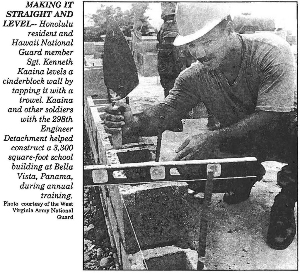 MAKING IT STRAIGHT AND LEVEL—Honolulu resident and Hawaii National Guard member Sgt. Kenneth Kaaina levels a cinderblock wall by tapping it with a trowel. Kaaina and other soldiers with the 298th Engineer Detachment helped construct a 3,300 square-foot school building at Bella Vista, Panama, during annual training. Photo courtesy of the West Virginia Army National Guard