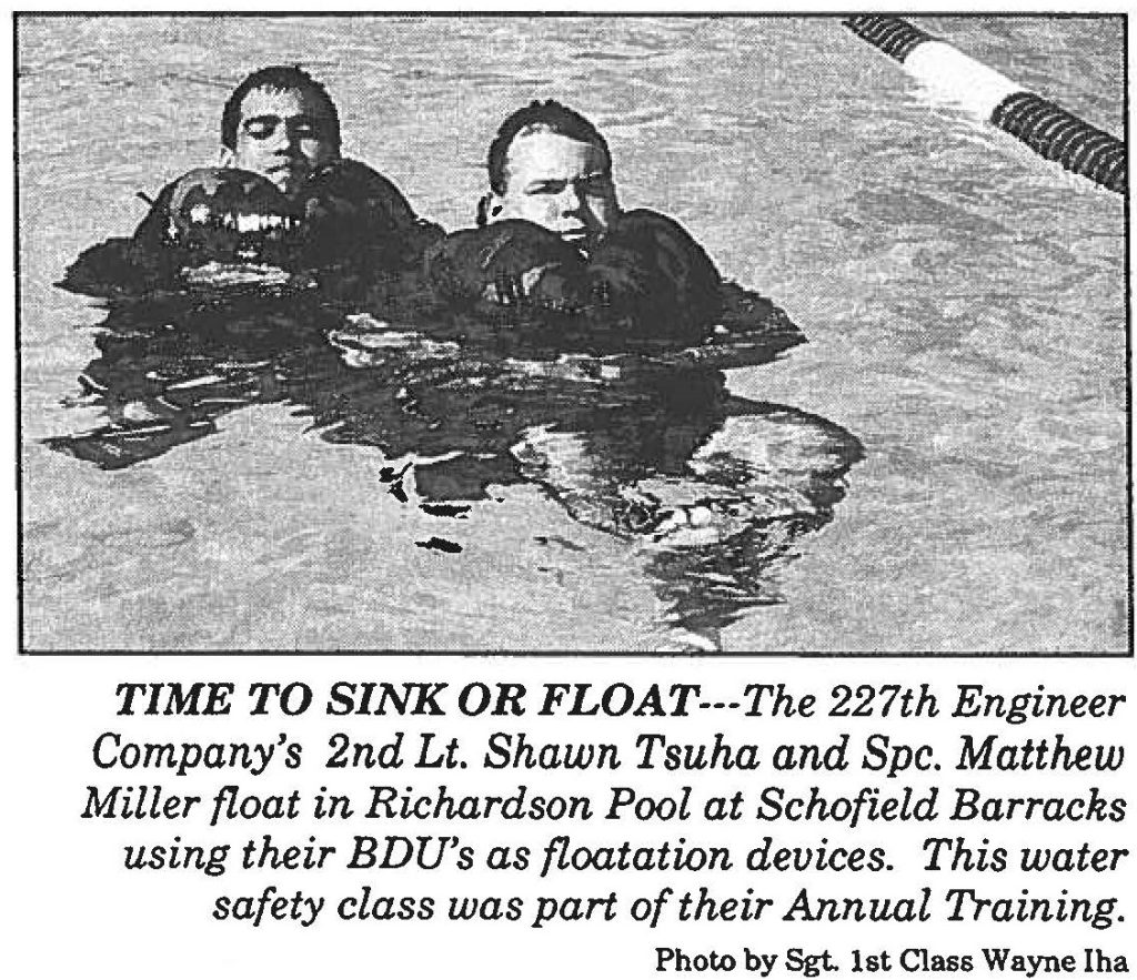 TIME TO SINK OR FLOAT-- The 227th Engineer Company's 2nd Lt. Shawn Tsuha and Spc. Matthew Miller float in Richardson Pool at Schofield Barracks using their BDU's as floatation devices. This water safety class was part of their Annual Training. Photo by Sgt. 1st Class Wayne Iha