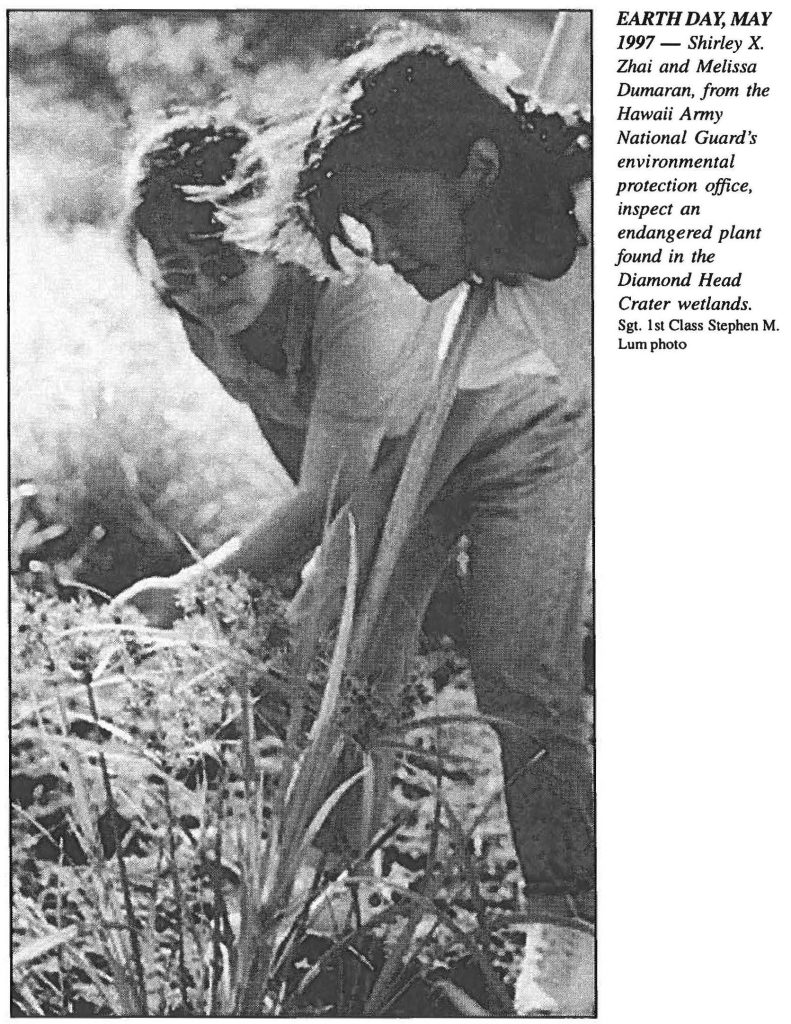 EARTH DAY, MAY 1997 - Shirley X. Zhai and Melissa Dumaran, from the Hawaii Army National Guard's environmental protection office, inspect an endangered plant found in the Diamond Head Crater wetlands. Sgt. 1st Class Stephen M. Lum photo