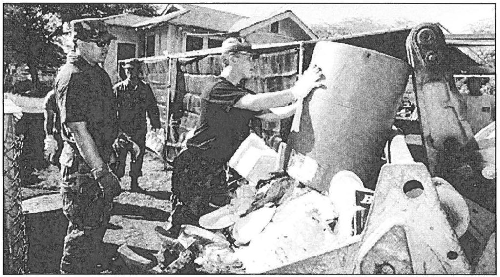 OPERATION KOKUA (above) - Hawaii Air National Guard airmen gather debris washed down by the election day flood on Oahu's Waianae coast. Sgt. 1st Class Wayne T. Iha photo