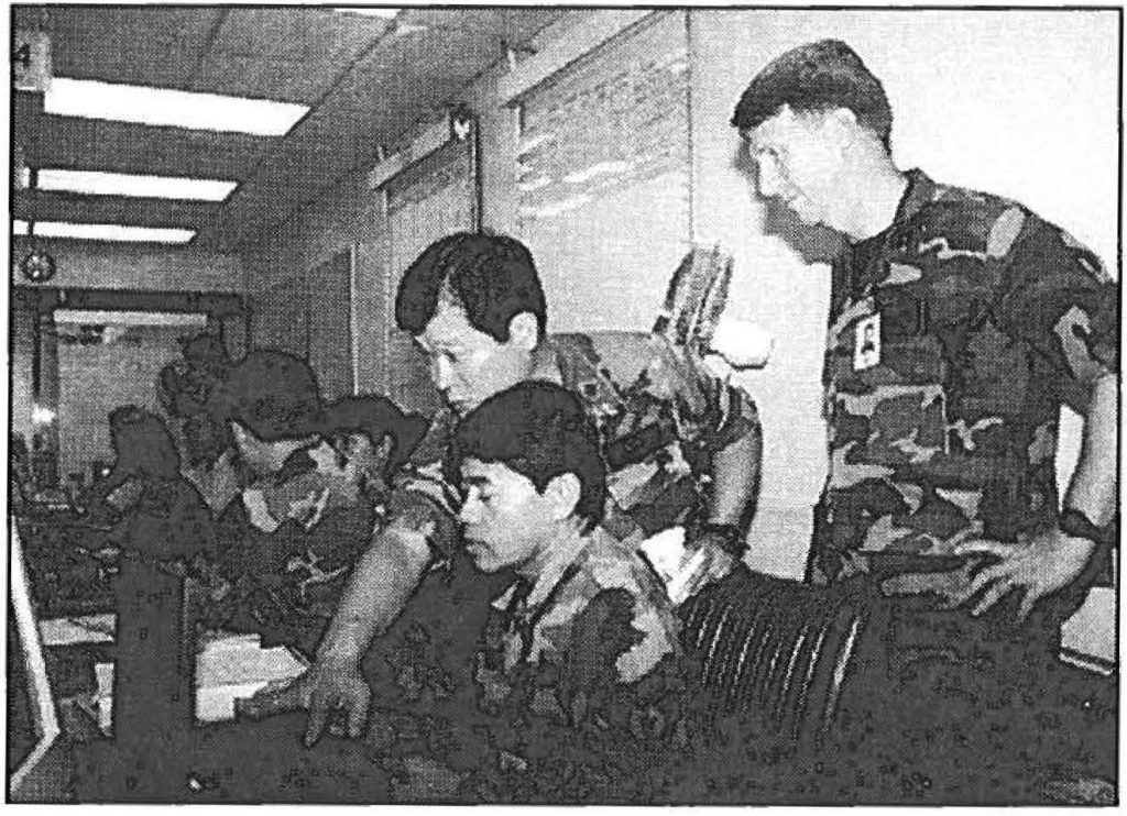 COOPERATION AND COORDINATION - Lt. Col. Blaine Izuka, Staff Sgt. Patrick Bailon, and Capt. Mike Doolin review situation reports during statewide hurricane exercise Makani Pahili in May. Capt. Charles J. Anthony photo