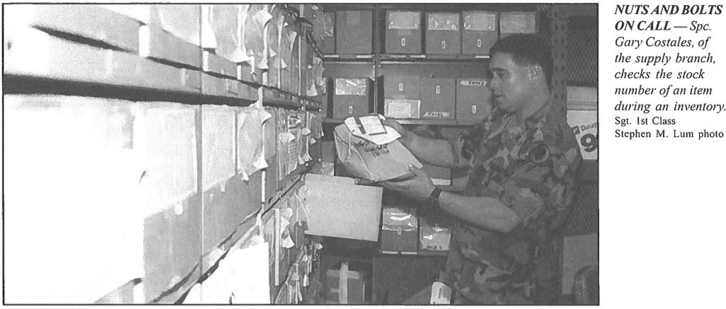 NUTS AND BOLTS ON CALL-Spc. Gary Costales, of the supply branch, checks the stock number of an item during an inventory Sgt. 1st Class Stephen M. Lum photo