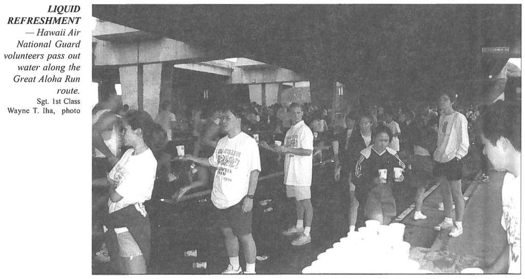 LIQUID REFRESHMENT - Hawaii Air National Guard volunteers pass out water along the Great Aloha Run route. Sgt. 1st Class Wayne T. Iha, photo