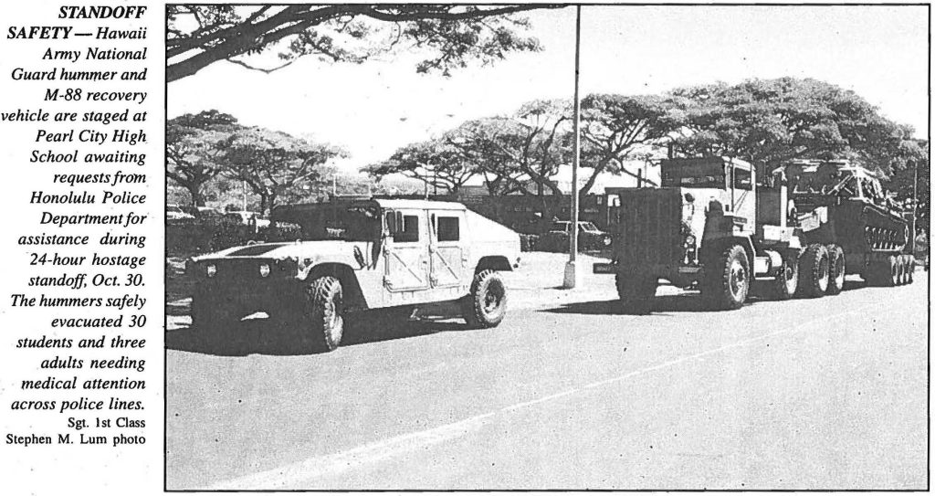 STANDOFF SAFETY – Hawaii Army National Guard hummer and M-88 recovery vehicle are staged at Pearl City High School awaiting requests from Honolulu Police Department for assistance during 24-hour hostage standoff, Oct. 30. The hummers safely evacuated 30 students and three adults needing medical attention across police lines. Sgt. 1st Class Stephen M. Lum photo