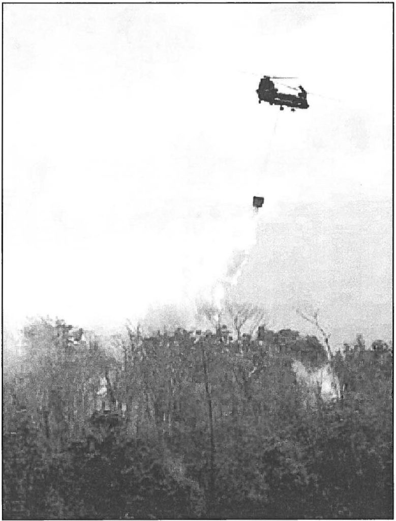 BURNING CONTROL-A Hawaii Army National Guard CH-47D Chinook helicopter fights the fire over Waipio Gentry in June. Ken Ige, Honolulu Star-Bulletin photo