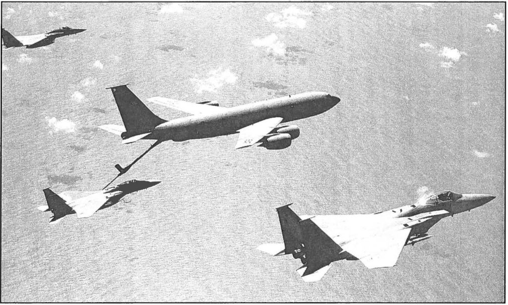 HAWAIIAN ARIEL GAS STATION - Hawaii Air National Guard KC-135R Stratotanker refuels her sister ship, the F-15 Eagle jetfighter. John A. Dibbs, The Picture Plane Co. photo