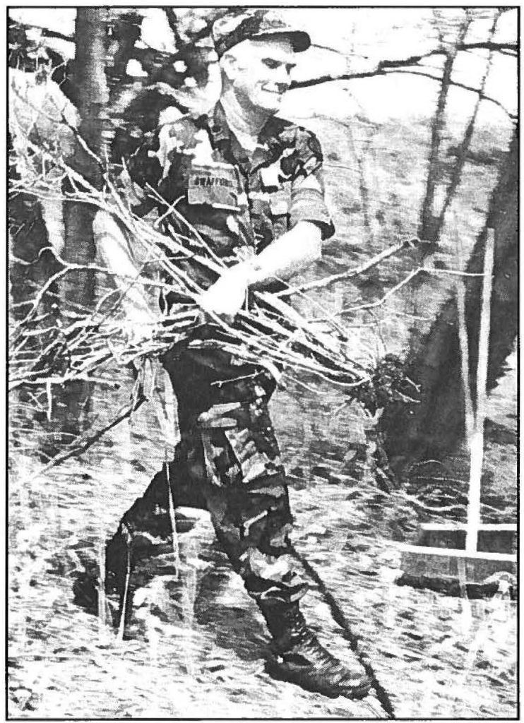 ALL IN A DAY'S WORK - Lt. Col. Ronald R. Swafford clears debris from the historic Battery Harlow. Cadet Wendy R. Cook photo