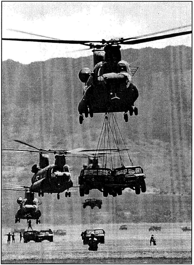 POWERLIFTING -Hawaii Army National Guard CH-47D Chinook helicopters from Company C, 193rd Aviation, slingload 25th Infantry Division (Light) vehicles from Oahu s Wheeler Army Airfield over water to Kauai’s Pacific Missile Range at Barking Sands. Sgt. 1st Class Wayne T. Iha photo