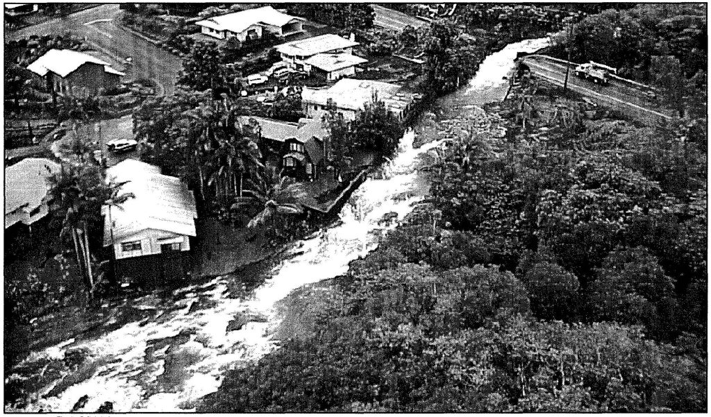 RAGING RAPIDS- A Hawaii Army National Guard reconnaissance photo from a UH- 60 Black Hawk helicopter, shows a Hilo stream overflowing and destroying a road, November 2000. Sgt. 1st Class Wayne T. Iha photo