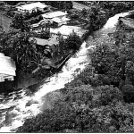 RAGING RAPIDS- A Hawaii Army National Guard reconnaissance photo from a UH- 60 Black Hawk helicopter, shows a Hilo stream overflowing and destroying a road, November 2000. Sgt. 1st Class Wayne T. Iha photo