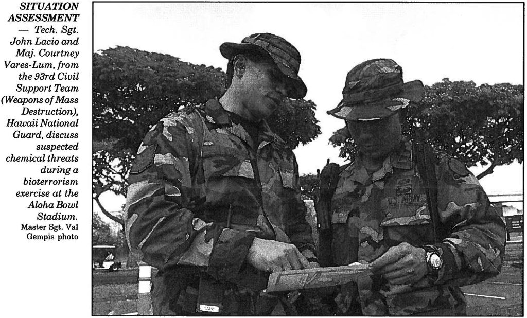 SITUATION ASSESSMENT - Tech. Sgt. John Lacio and Maj. Courtney Vares-Lum, from the 93rd Civil Support Team (Weapons of Mass Destruction), Hawaii National Guard, discuss suspected chemical threats during a bioterrorism exercise at the Aloha Bowl Stadium. Master Sgt. Val Gempis photo