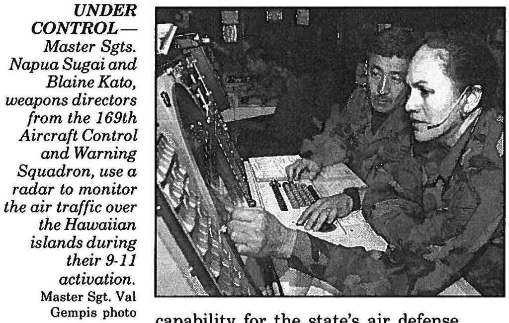 UNDER CONTROL Master Sgts. Napua Sugai and Blaine Kato, weapons directors from the 169th Aircraft Control and Warning Squadron, use a radar to monitor the air traffic over the Hawaiian islands during their 9-11 activation. Master Sgt. Val Gempis photo