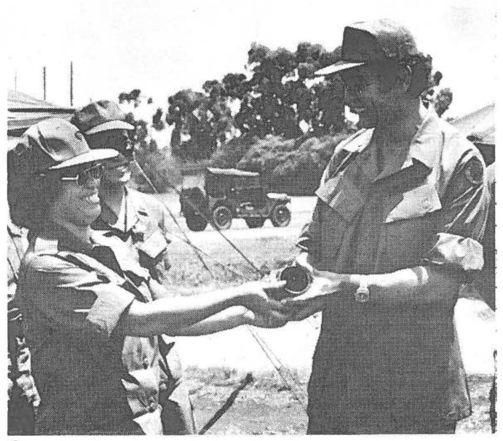 Sp5 Norma McDonald- HHD, 159th Svc Bn - presents Governor George Ariyoshi with a token of appreciation from the 298th Field Depot, after the Governor's tour - AT 75