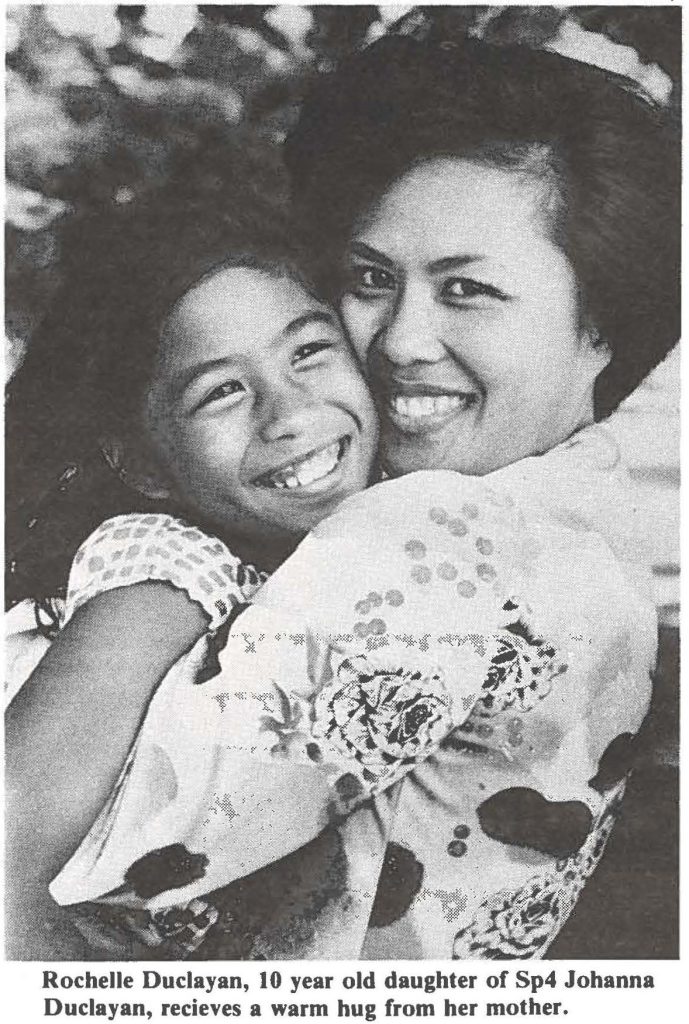 Rochelle Duclayan, 10 year old daughter of Sp4 Johanna Duclayan, receives a warm hug from her mother.