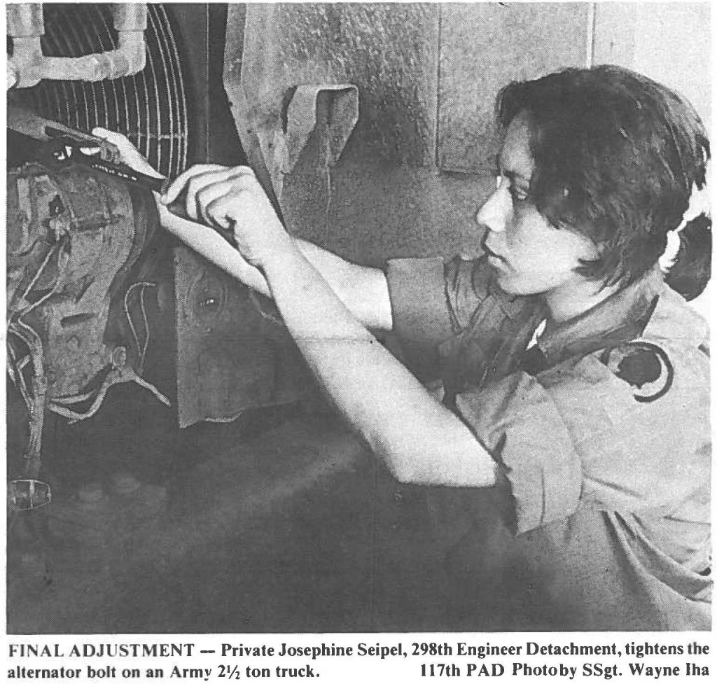 FINAL ADJUSTMENT - Private Josephine Seipel, 298th Engineer Detachment, tightens the alternator bolt on an Army 2½ ton truck. 117th PAD Photo by SSgt. Wayne Iha