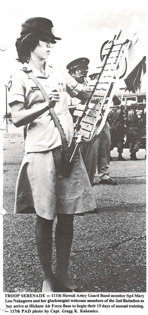 TROOP SERENADE -111th Hawaii Army Guard Band member Sp4 Mary Lou Nakagawa and her glockenspiel welcome members of the 2nd Battalion as they arrive at Hickam Air Force Base to begin their 15 days of annual training. - 117th PAD photo by Capt. Gregg K. Kakesako.