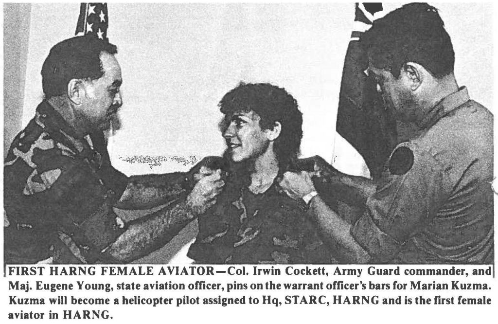 FIRST HARNG FEMALE AVIATOR-Col. Irwin Cockett, Army Guard commander, and Maj. Eugene Young, state aviation officer, pins on the warrant officer's bars for Marian Kuzma. Kuzma will become a helicopter pilot assigned to Hq, ST ARC, HARNG and is the first female aviator in HARNG.
