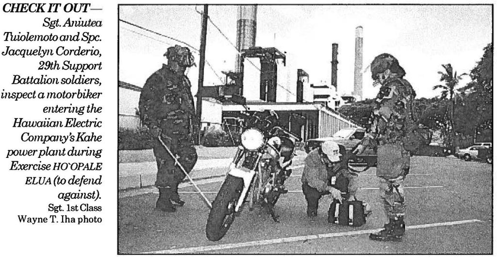 CHECK IT OUT Sgt. Aniutea Tuiolemoto and Spc. Jacquelyn Corderio, 29th Support Battalion soldiers, inspect a motorbiker entering the Hawaiian Electric Company's Kahe power plant during Exercise HO'OPALE ELUA (to defend against). Sgt. 1st Class Wayne T. Iha photo