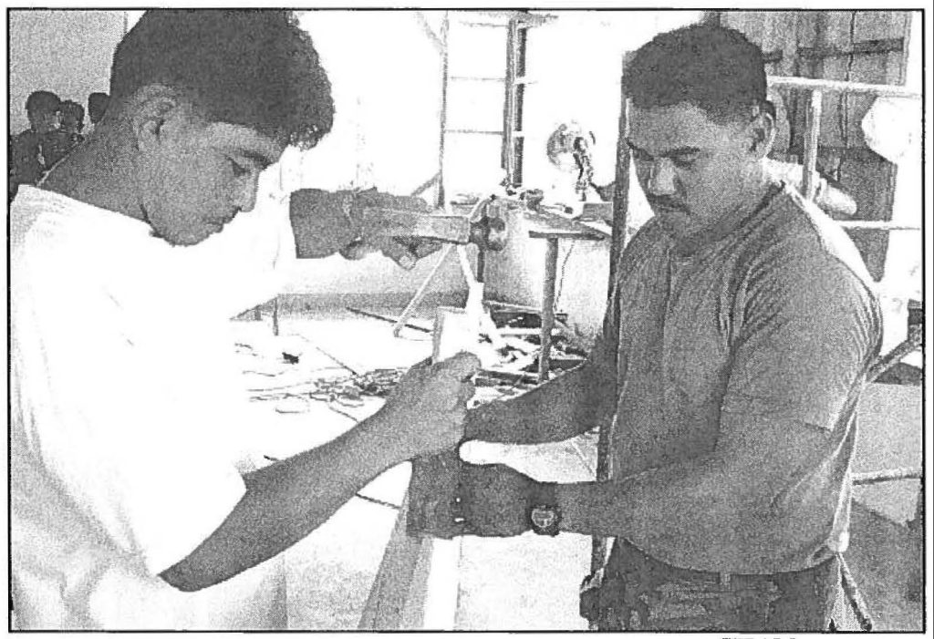 TEAM WORKERS Sgt. Joel Ballestesteros (right), a 298th Engineer Detachment soldier, works with an airman from the Filipino Air Force to make a "form" to be used for pouring cement during Exercise BALIKATAN in the Philippines. Staff Sgt. Haunani Lo photo