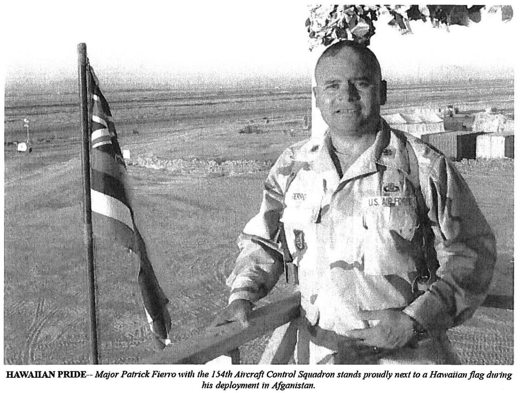 HAWAIIAN PRIDE-- Major Patrick Fierro with the154th Aircraft Control Squadron stands proudly next to a Hawaiian flag during his deployment in Afghanistan.