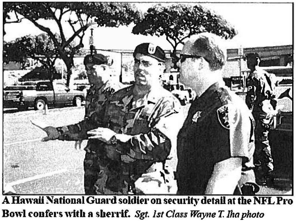 A Hawaii National Guard solider on security detail at the NFL Pro Bowl confers with a sheriff. Sgt. 1st Class Wayne T. Iha photo