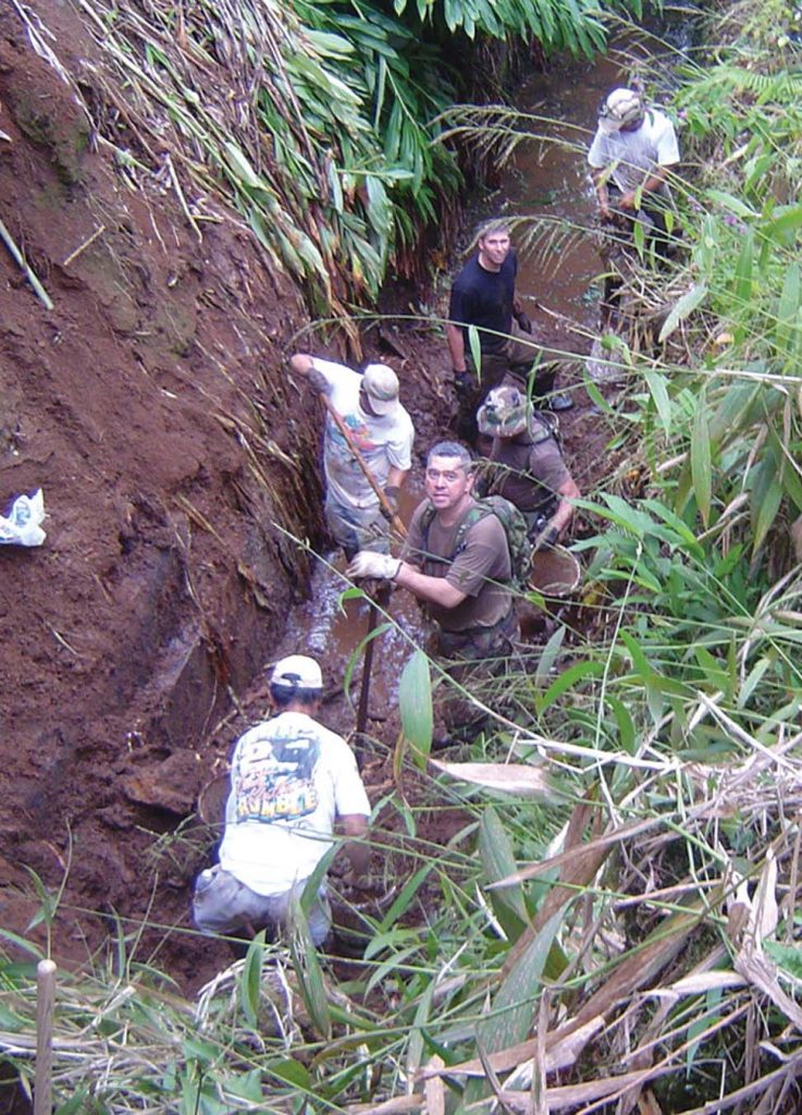 COMMUNITY SERVICE -- Hawaii National Guard troops and volunteers work together to clear the Hamakua ditch from earthquake debris. Courtesy photo