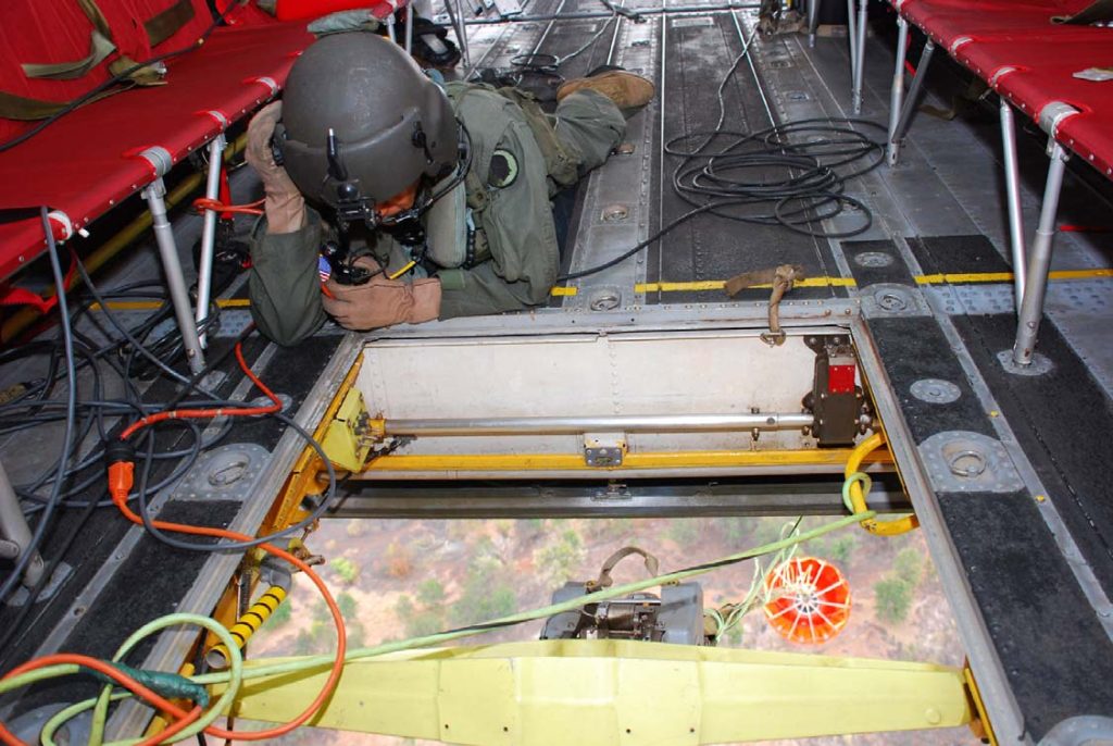 FIRE MISSION –– A Hawaii Army National Guard Soldier spots for a CH-47D Chinook helicopter water bucket drop during the Waialua fire suppression mission in August 2007. Sgt. 1st Class Wayne T. Iha photo