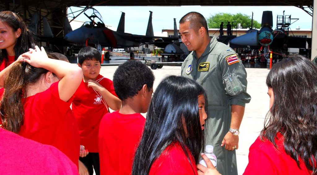 YOUTHFUL INQUIRY -- F-15 Eagle jetfighter pilot 1st Lt. Curtis Yoshimoto answers questions from Hawaii National Guard Youth Camp attendees about the aircraft and equipment. Sgt. 1st Class Wayne T. Iha photo