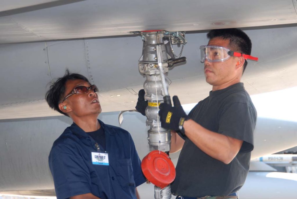 INTERNATIONAL GROUNDCREW -- Staff Sgt. Daryle Lum (right), from the 154th Maintenance Group, works with an airman from the Royal Thai Air Force to refuel an F-15 Eagle jetfighter during the Thailand-based Exercise COPE TIGER deployment in February 2007. Master Sgt. Kristen Stanley photo