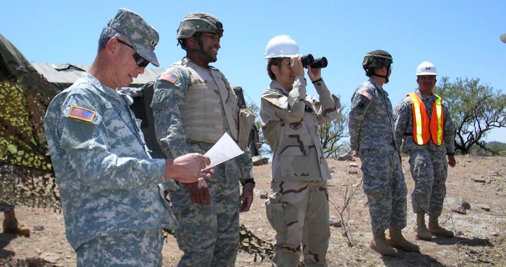 TEAMWORK -- Maj. Gen. Robert G.F. Lee, the adjutant general and Command Chief Master Sgt. Denise M. Jelinski-Hall (with binoculars) observe the 29th Brigade Special Troops Battalion Soldiers performing their entry identification team mission for Operation JUMP START in Arizona. Lt. Col. Moses Kaoiwi photo