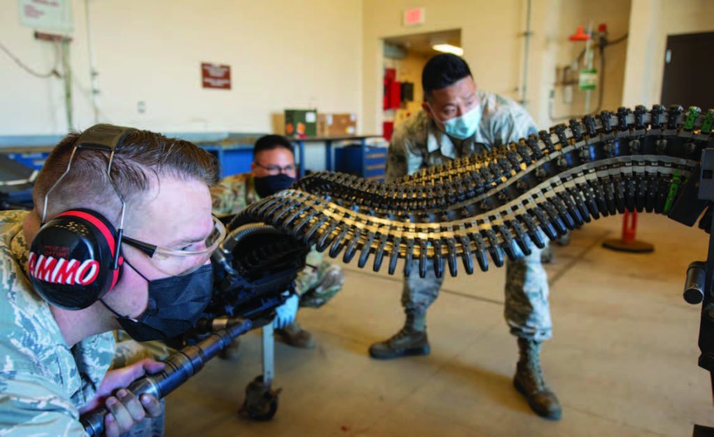 HIANG ammo Airmen keep raptors armed and ready, JBPH-H, HI. The 154th Maintenance Squadron munition systems specialists load 20 mm rounds into a Universal Ammunition Loading System at JBPH-H. The UALS in turn will be used to arm an F-22 Raptor assigned to the HIANG's 199th Fighter Squadron. (Photo by: Staff Sgt. Orlando Corpuz)