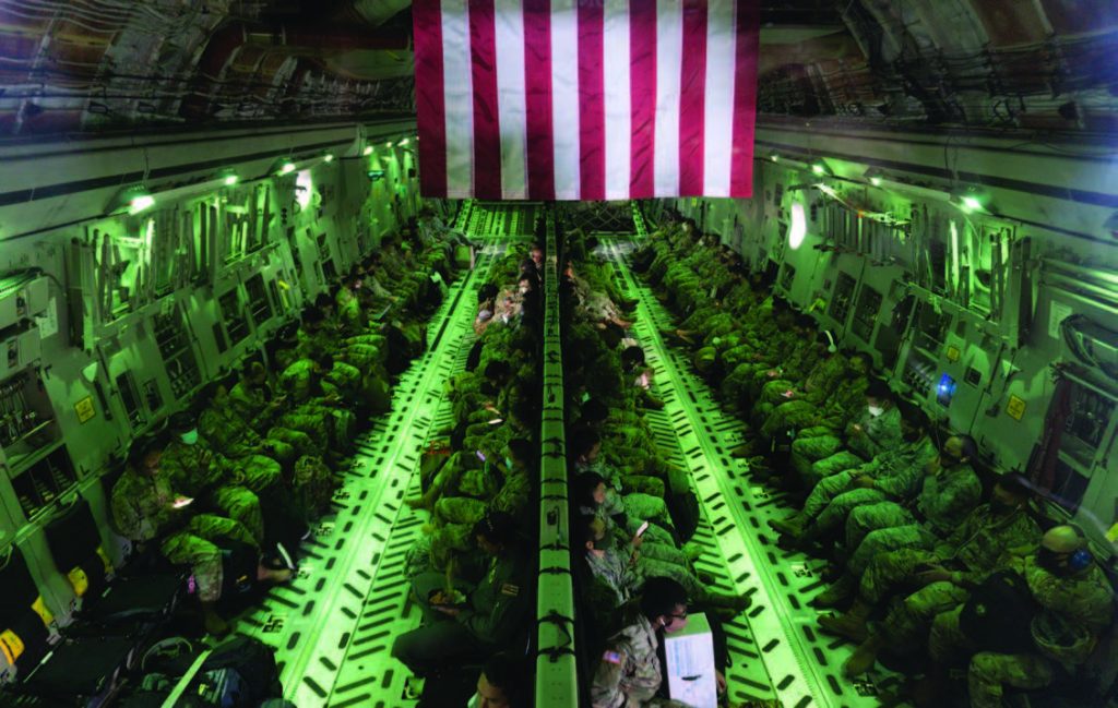 Hawai‘i National Guard Task Forces Airlifted Home from Neighboring Islands, HI. Hawai‘i National Guard Airmen and Soldiers prepare for transit on a C-17 Globemaster III at Kahului Airport. The guardsmen were airlifted from neighboring islands and back to O‘ahu by the 204th Airlift Squadron after serving in various task forces to help the state mitigate the spread of COVID-19. (Photo by: Tech. Sgt. Alison Bruce-Maldonado).