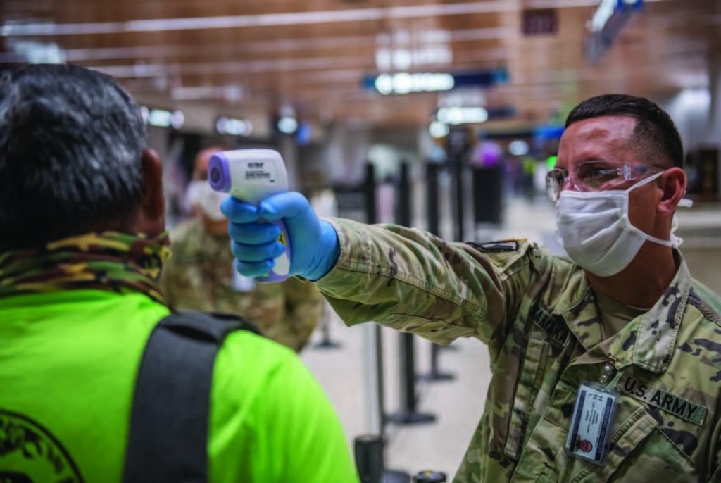 Hawai‘i National Guard conduct medical screenings at Hawai‘i airports during COVID-19 pandemic, Honolulu, HI. Spc. James Kamaka with the 1st Squadron, 299th Cavalry, screens departing passengers at the Daniel K. Inouye International Airport. HING Soldiers assisted airport fire personnel screening 100% of travelers arriving and departing to the State of Hawai‘i. (Photo by: Sgt. John Schoebel)