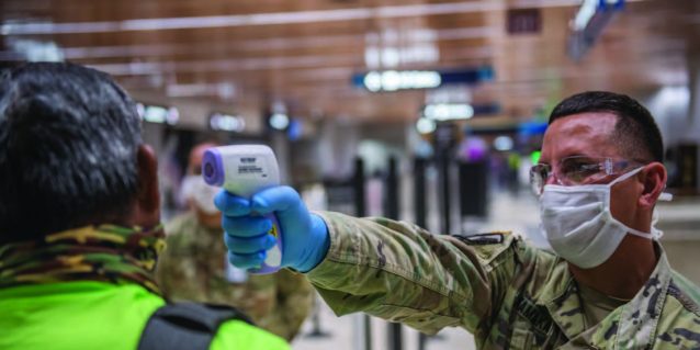 Hawai‘i National Guard conduct medical screenings at Hawai‘i airports during COVID-19 pandemic, Honolulu, HI. Spc. James Kamaka with the 1st Squadron, 299th Cavalry, screens departing passengers at the Daniel K. Inouye International Airport. HING Soldiers assisted airport fire personnel screening 100% of travelers arriving and departing to the State of Hawai‘i. (Photo by: Sgt. John Schoebel)