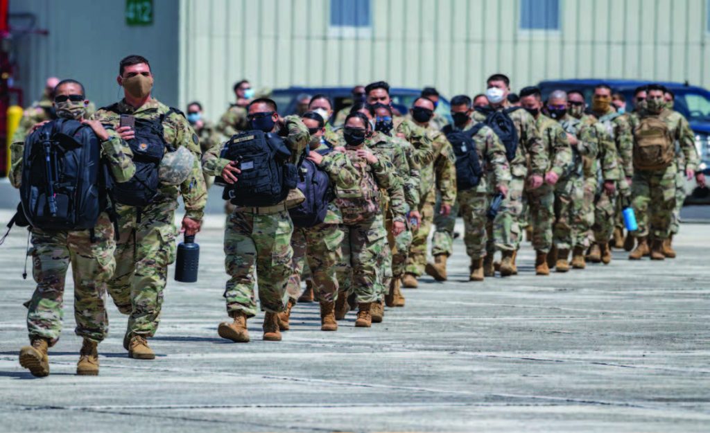 Hawai‘i National Guard COVID-19 neighbor island response, HI. Members of the Hawai‘i National Guard line up to board a C-17 from the 204th Airlift Squadron, which made several runs of troops to Maui, Kauai, and Hawaii Island to assist with the state's COVID-19 response. Nearly 800 HING members were activated over the first week of April. (Photo by: Sgt. John Schoebel)