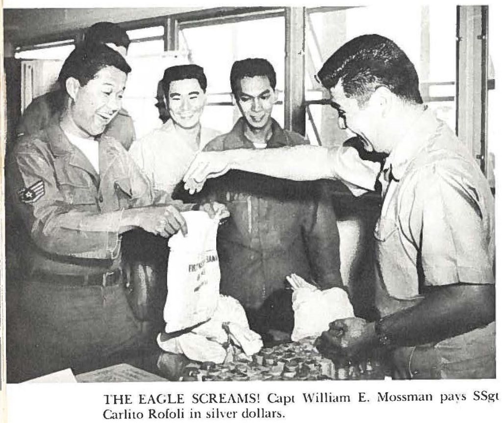 THE EAGLE SCREAMS! Capt William E. Mossman pays SSgt Carli to Rofoli in silver dollars.