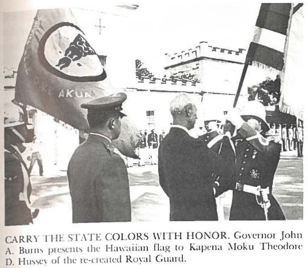 CARRY THE STATE COLORS WITH HONOR. Governor John A. Burns presents the Hawaiian flag to Kapena Moku Theodore D. Hussey of the recreated Royal Guard.