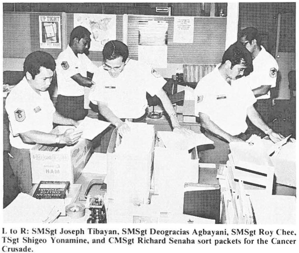 L to R: SMSgt Joseph Tibayan, SMSgt Deogracias Agbayani, SMSgt Roy Chee, TSgt Shigeo Yonamine, and CMSgt Richard Senaha sort packets for the Cancer Crusade.