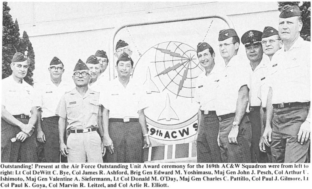 Outstanding! Present at the Air Force Outstanding nit Award ceremony for the 169th AC&W Squadron were from left to right: Lt Col DeWitt C. Bye, Col James R. Ashford, Brig Gen Edward M. Yoshimasu, Maj Gen John J. Pesch, Col Arthur U. lshimoto, Maj Gen Valentine A. Siefermann, Lt Col Donald M. O'Day, Maj Gen Charles C. Pattillo, Col Paul J. Gilmorr. Lt Col Paul K. Goya, Col Marvin R. Leitzel, and Col Arlie R. Elliott.