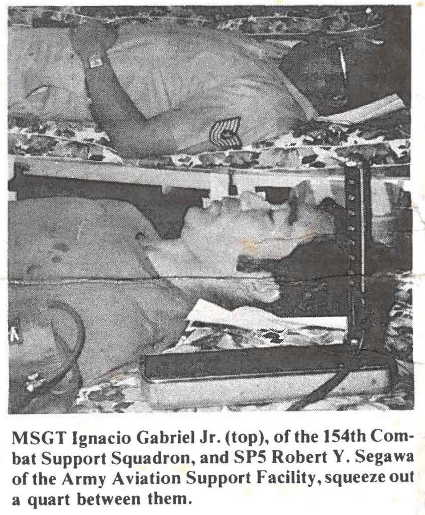 MSGT Ignacio Gabriel Jr. (top), of the 154th Combat Support Squadron, and SPS Robert Y. Segawa of the Army Aviation Support Facility, squeeze out a quart between them.