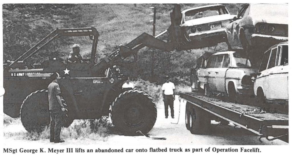 MSgt George K. Meyer III lifts an abandoned car onto flatbed truck as part of Operation Facelift.