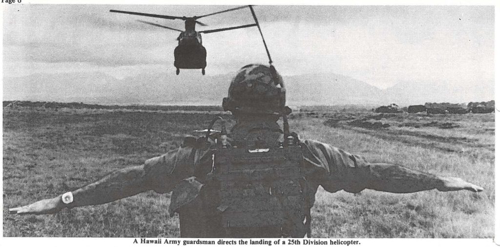 A Hawaii Army guardsman directs the landing of a 25th Division helicopter.